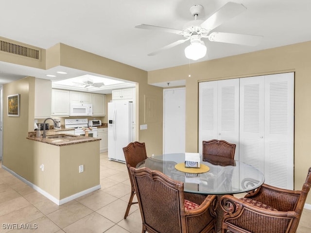 dining room featuring light tile patterned floors, ceiling fan, and sink