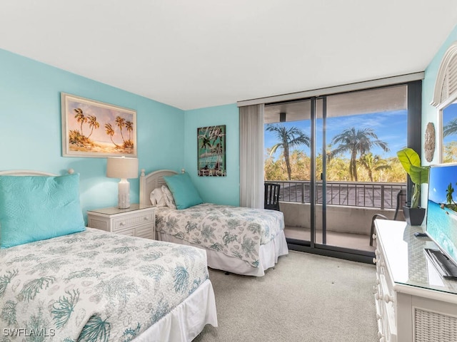 bedroom with access to outside, multiple windows, light carpet, and floor to ceiling windows