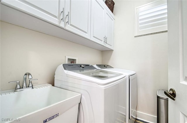 laundry room featuring cabinets, washing machine and dryer, and sink