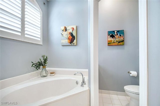 bathroom featuring tile patterned floors, toilet, and a tub