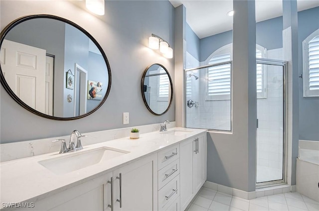 bathroom with tile patterned flooring, vanity, and a shower with shower door