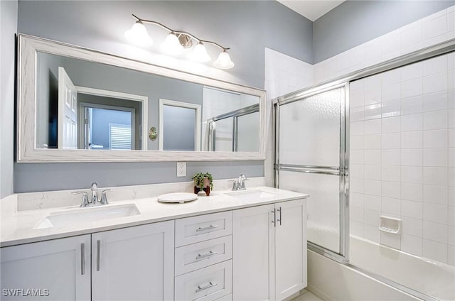 bathroom featuring vanity and combined bath / shower with glass door