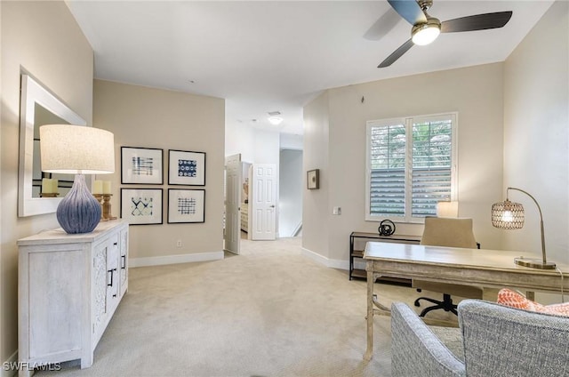 carpeted office featuring ceiling fan