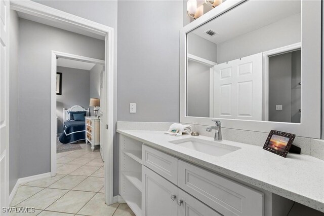 bathroom featuring tile patterned flooring and vanity