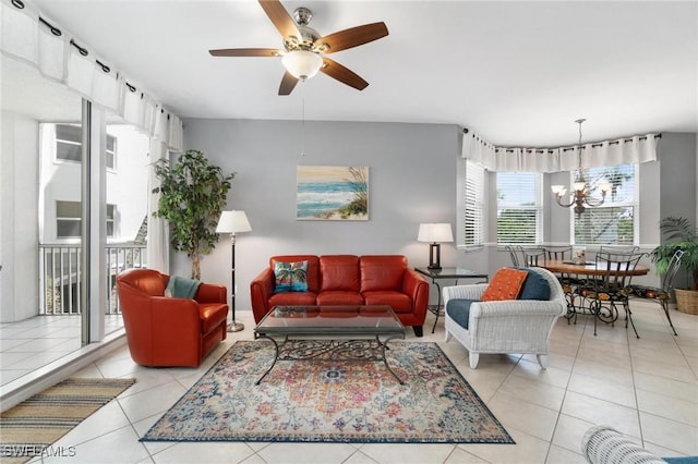 tiled living room with ceiling fan with notable chandelier