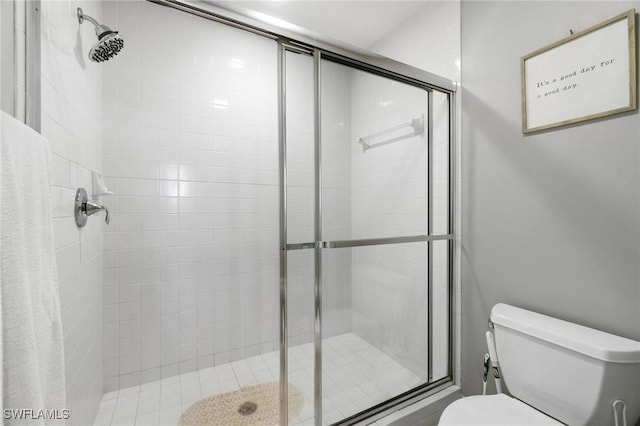 bathroom with an enclosed shower and toilet