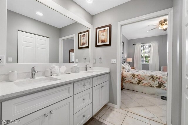 bathroom with ceiling fan, tile patterned flooring, and vanity