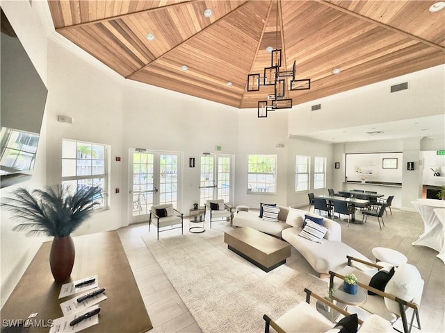 living room featuring a high ceiling, french doors, and wood ceiling