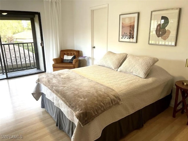 bedroom featuring access to exterior and light wood-type flooring