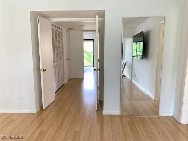 hallway with light hardwood / wood-style flooring