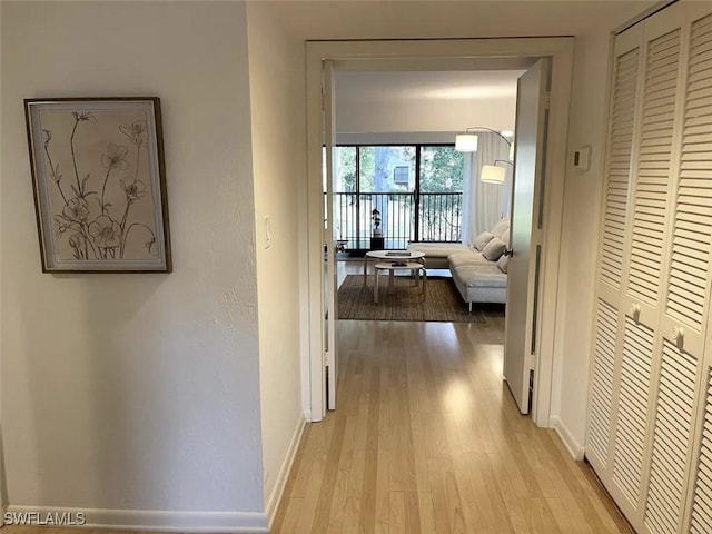 corridor with light hardwood / wood-style flooring