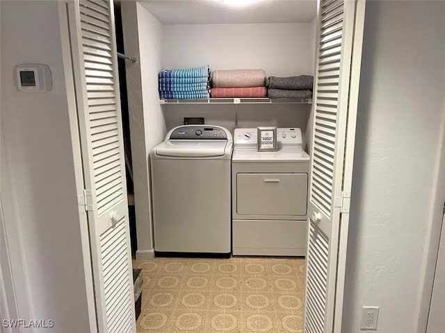 laundry area featuring washing machine and clothes dryer