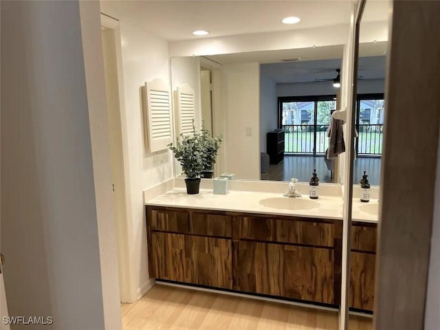 bathroom featuring vanity, ceiling fan, and wood-type flooring