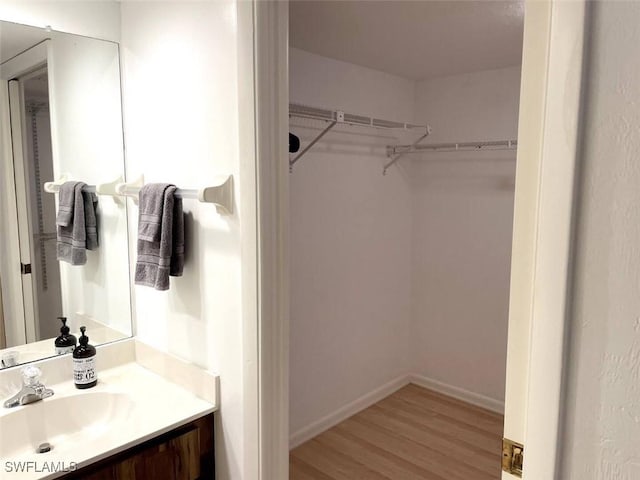 bathroom with hardwood / wood-style floors and vanity