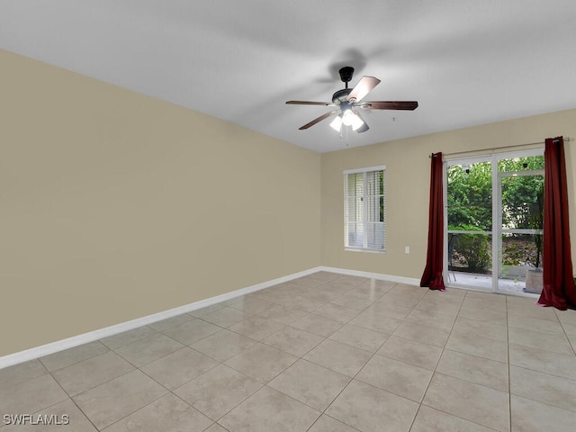 empty room featuring ceiling fan and light tile patterned floors