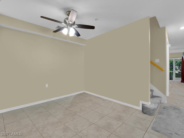 tiled empty room with ceiling fan