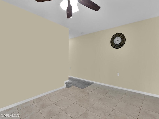 unfurnished room with ceiling fan and light tile patterned floors