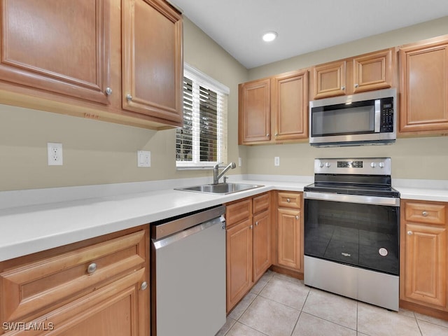 kitchen featuring light tile patterned floors, stainless steel appliances, and sink