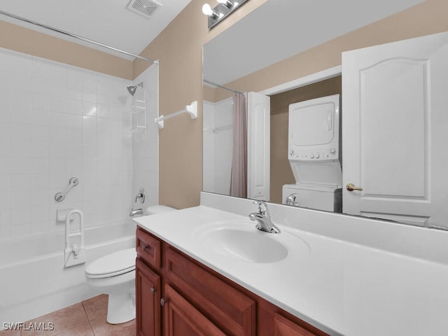 full bathroom with tile patterned flooring, toilet, shower / bath combo with shower curtain, vanity, and stacked washer and clothes dryer