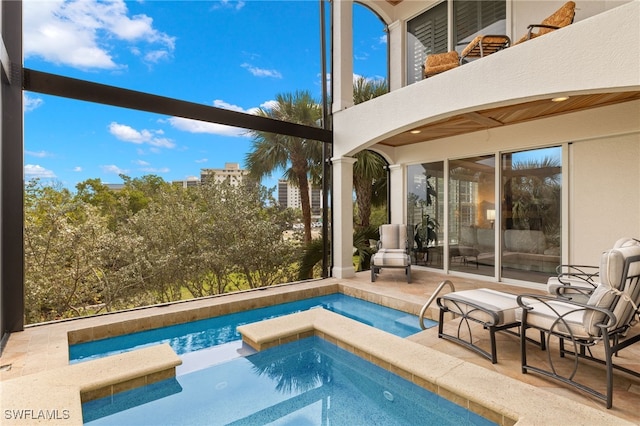 view of swimming pool featuring an in ground hot tub