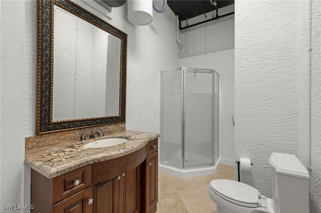 bathroom featuring toilet, vanity, and walk in shower