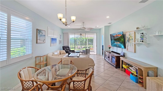 interior space featuring ceiling fan with notable chandelier