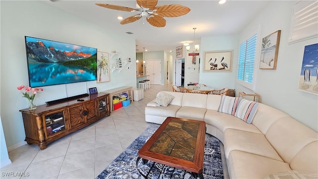 living room featuring light tile patterned floors and ceiling fan with notable chandelier