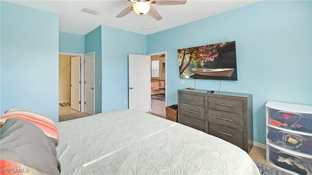 bedroom featuring ceiling fan and ensuite bathroom