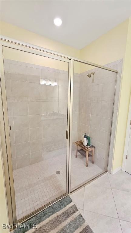 bathroom featuring tile patterned floors and an enclosed shower