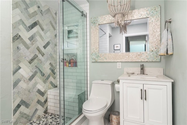 bathroom with toilet, vanity, an inviting chandelier, and walk in shower