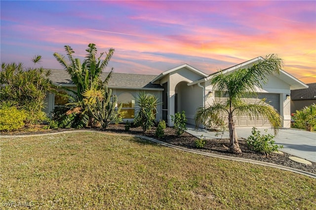 single story home with a lawn and a garage