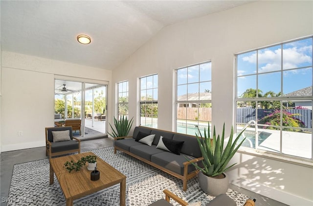 sunroom featuring ceiling fan and lofted ceiling