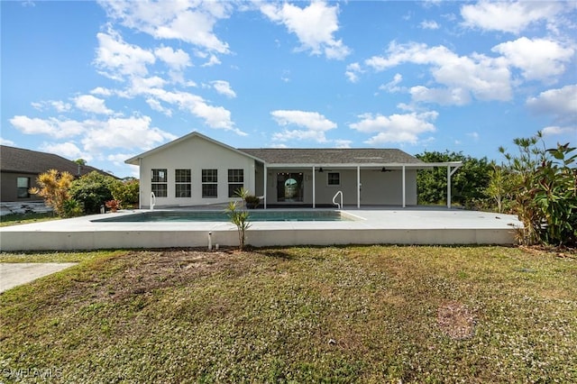 back of property featuring a patio area and a yard