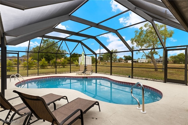 view of swimming pool with a lanai, a lawn, and a patio