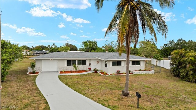 ranch-style home featuring a garage and a front lawn