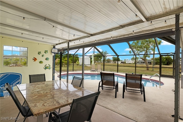 view of patio / terrace with a lanai and a storage shed