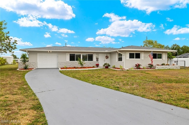 ranch-style home with a garage and a front lawn