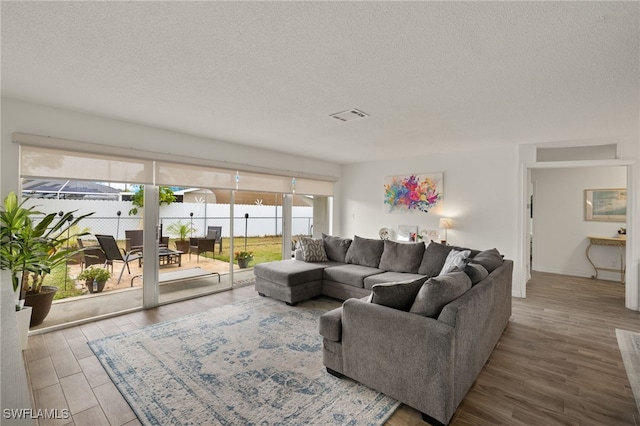 living room with hardwood / wood-style floors and a textured ceiling