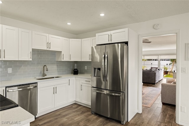 kitchen featuring white cabinetry, sink, dark wood-type flooring, and appliances with stainless steel finishes