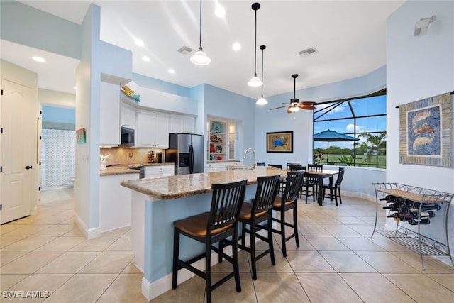 kitchen with light tile patterned floors, visible vents, white cabinets, and appliances with stainless steel finishes