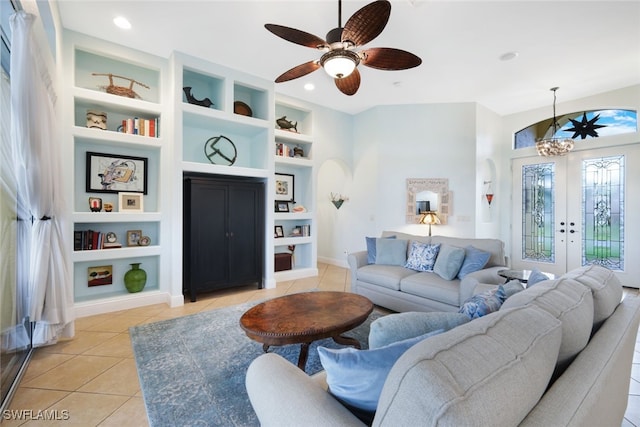 living room with light tile patterned floors, built in shelves, baseboards, recessed lighting, and french doors