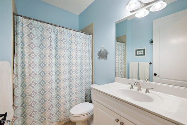 bathroom featuring a shower with shower curtain, toilet, and vanity