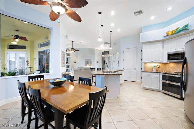 dining space with sink and light tile patterned floors