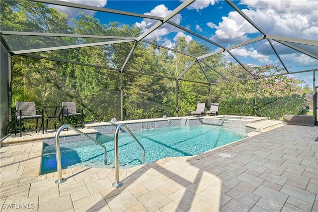 view of swimming pool with glass enclosure and a patio