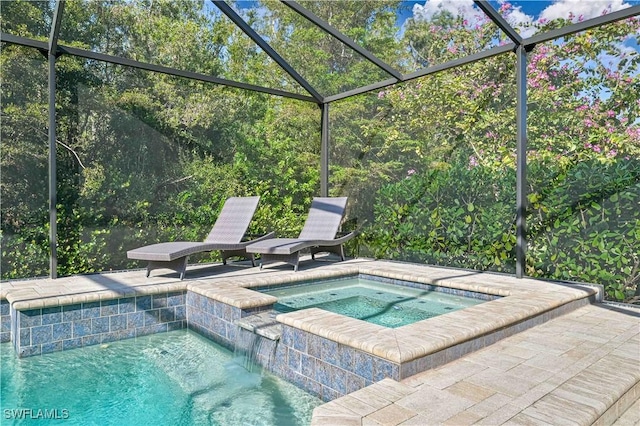 view of pool with a lanai and an in ground hot tub