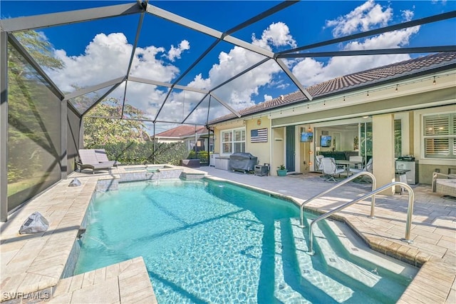 view of pool featuring an in ground hot tub, a lanai, pool water feature, grilling area, and a patio