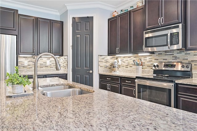 kitchen with appliances with stainless steel finishes, backsplash, light stone counters, and dark brown cabinets