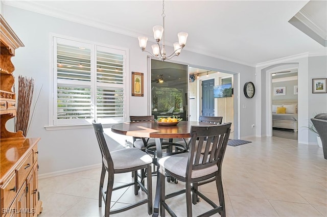 dining space featuring crown molding, light tile patterned flooring, and an inviting chandelier