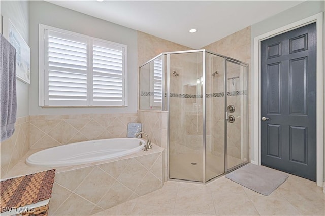 bathroom featuring tile patterned flooring and separate shower and tub