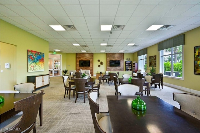 dining space featuring a drop ceiling